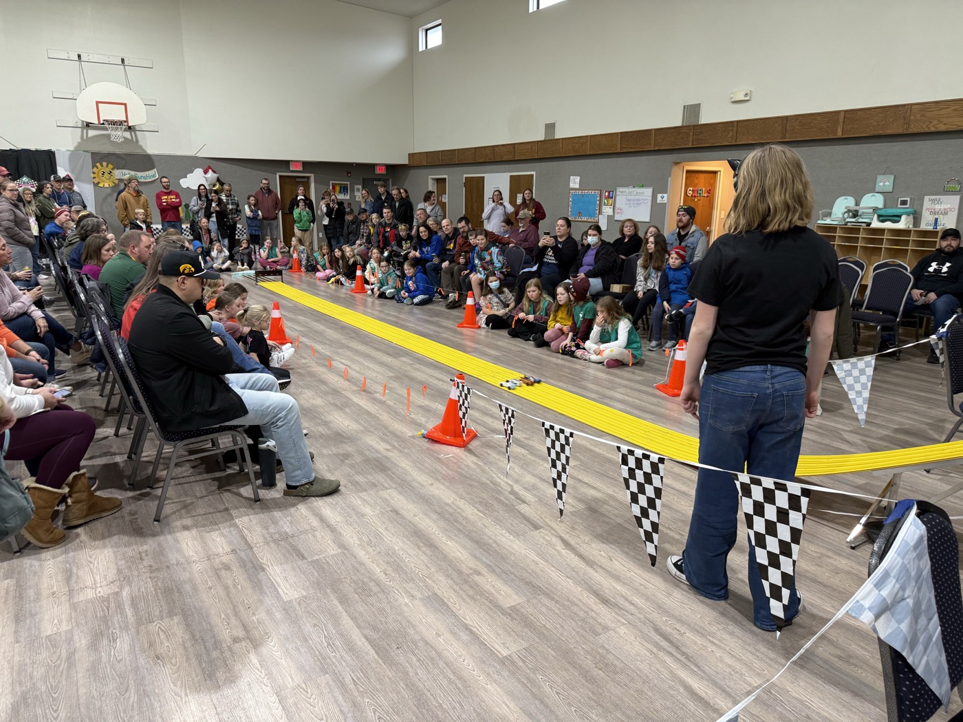 Families gathered along the pinewood derby track.